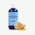 A bottle of ALittlePence Eczema Shampoo with a blue label and white cap, shown on a light background with a piece of natural shea and honey in the foreground.