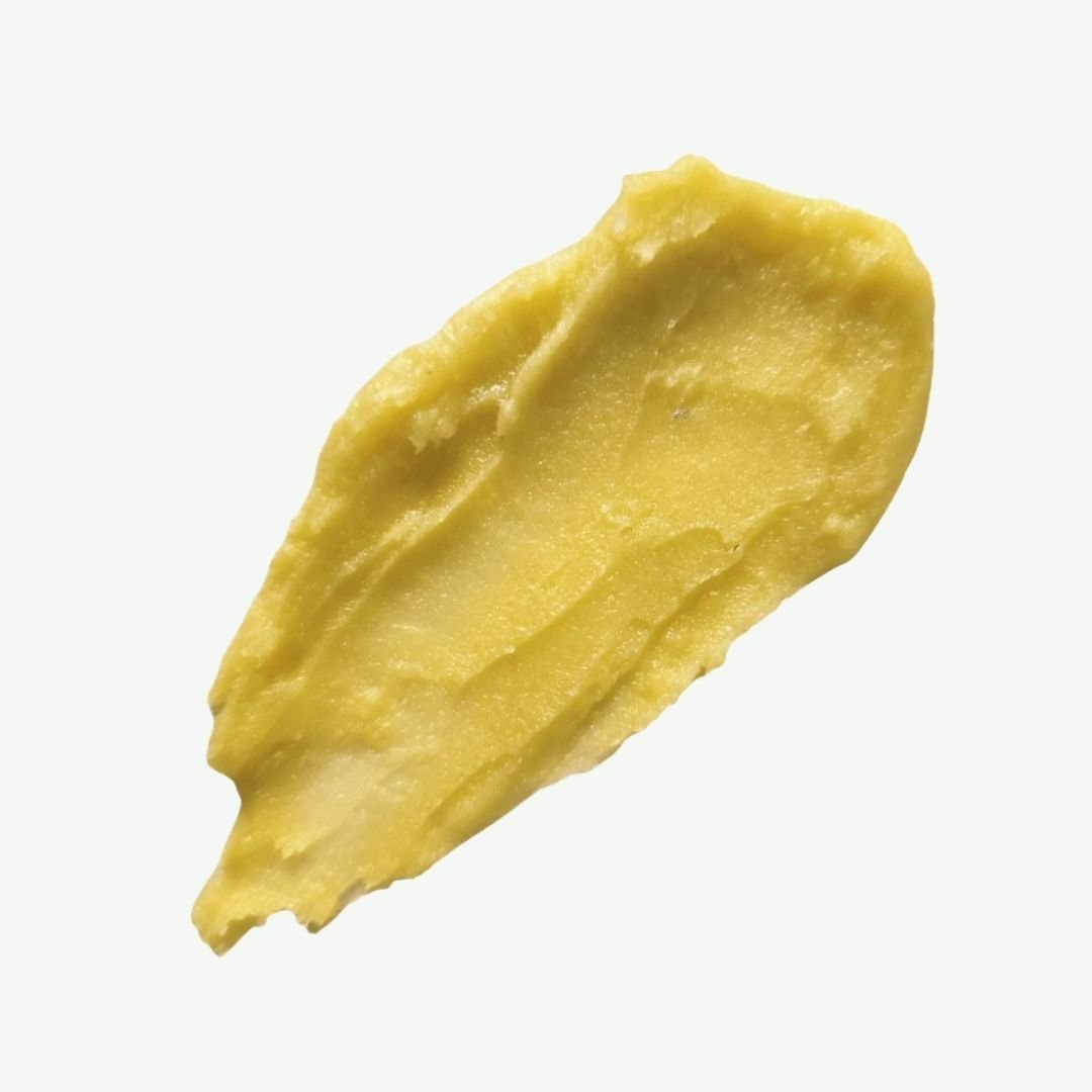 ALittlePeace Nour Body Balm swatch showing a creamy, yellow‑tinted balm on a clean light background, highlighting its rich, nourishing formula.
